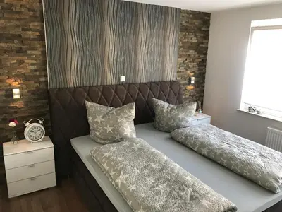 Ein Bett oder Betten in einem Zimmer der Unterkunft Ermmes Ferienwohnungen