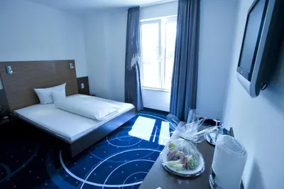 Ein Bett oder Betten in einem Zimmer der Unterkunft Hotel City Oase Lb