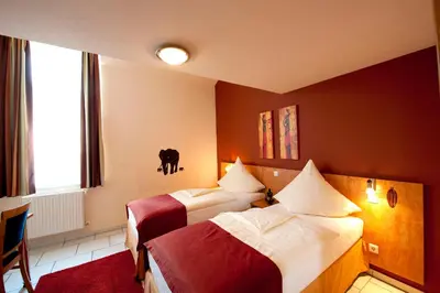 Ein Bett oder Betten in einem Zimmer der Unterkunft Hotel Alt Speyer