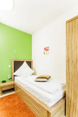 Ein Bett oder Betten in einem Zimmer der Unterkunft Hotel Maxis - digitaler Self-check-in -