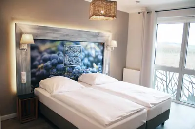 Ein Bett oder Betten in einem Zimmer der Unterkunft Winzerhotel Trautwein
