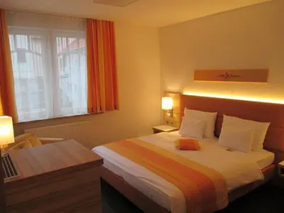 Ein Bett oder Betten in einem Zimmer der Unterkunft Schlosshotel Ingelfingen