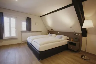 Ein Bett oder Betten in einem Zimmer der Unterkunft Gästehaus zur Sonne