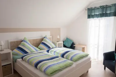 Ein Bett oder Betten in einem Zimmer der Unterkunft Winzerhof Schwerdt