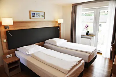 Ein Bett oder Betten in einem Zimmer der Unterkunft Garni-Hotel zur Krone