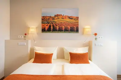 Ein Bett oder Betten in einem Zimmer der Unterkunft Parkhotel Landau