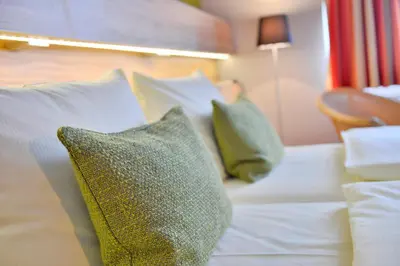 Ein Bett oder Betten in einem Zimmer der Unterkunft Parkhotel Landau