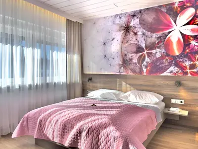 Ein Bett oder Betten in einem Zimmer der Unterkunft ART-Hotel Braun