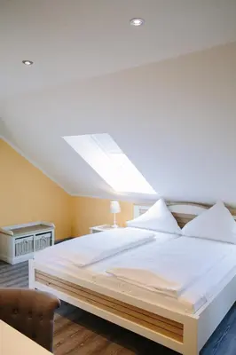 Ein Bett oder Betten in einem Zimmer der Unterkunft Gästehäuser Kappelmühle