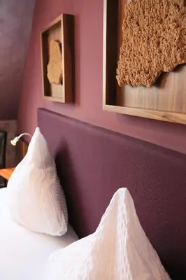 Ein Bett oder Betten in einem Zimmer der Unterkunft Bio-Weingut, Gästehaus und Kräuterhof