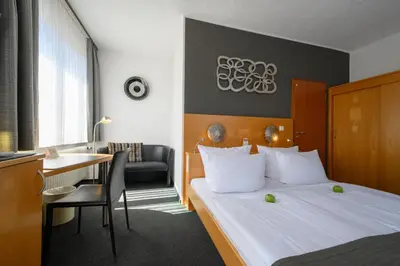 Ein Bett oder Betten in einem Zimmer der Unterkunft Hotel Heymann