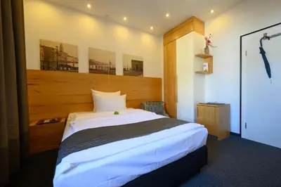 Ein Bett oder Betten in einem Zimmer der Unterkunft Hotel Heymann