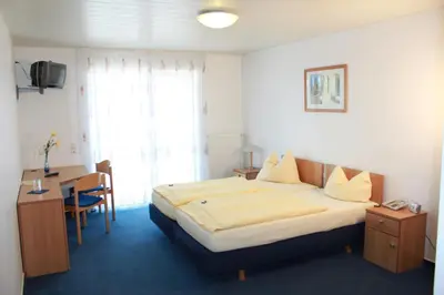 Ein Bett oder Betten in einem Zimmer der Unterkunft Hotel Gramlich