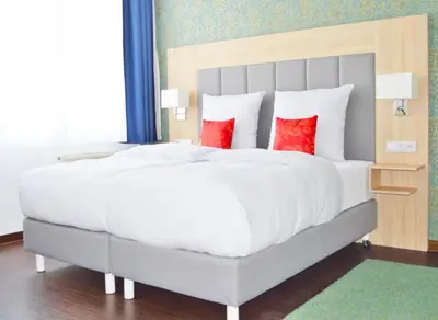 Ein Bett oder Betten in einem Zimmer der Unterkunft Pallas Hotel