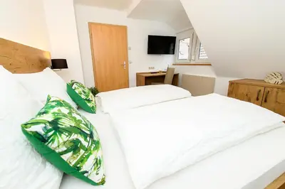 Ein Bett oder Betten in einem Zimmer der Unterkunft Zum Scheffelhof