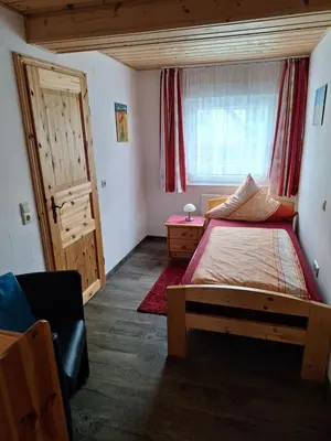Ein Bett oder Betten in einem Zimmer der Unterkunft Gästehaus Rüger
