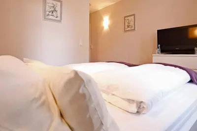 Ein Bett oder Betten in einem Zimmer der Unterkunft WEINreich, Gästezimmer & Weinstube