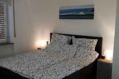 Ein Bett oder Betten in einem Zimmer der Unterkunft TOP gelegenes Appartment tla mit Garten für bis zu 5 Personen