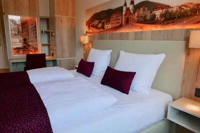Ein Bett oder Betten in einem Zimmer der Unterkunft Rafaela Hotel Heidelberg