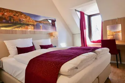 Ein Bett oder Betten in einem Zimmer der Unterkunft Rafaela Hotel Heidelberg