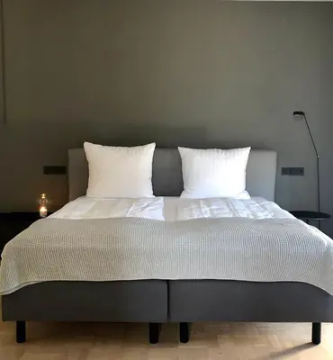 Ein Bett oder Betten in einem Zimmer der Unterkunft Der Grüne Baum