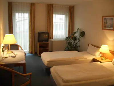 Ein Bett oder Betten in einem Zimmer der Unterkunft Weinhotel Wagner