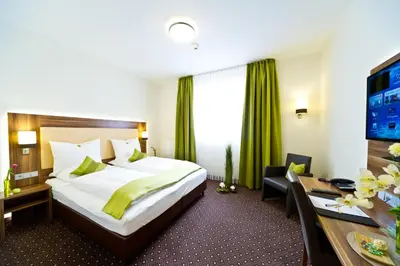 Ein Bett oder Betten in einem Zimmer der Unterkunft Wohlfühl-Hotel Neu Heidelberg