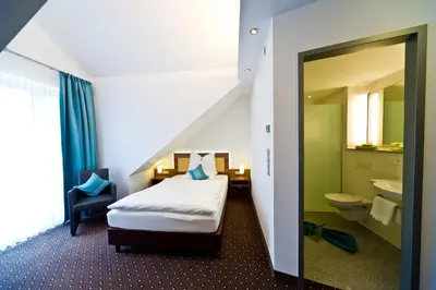Ein Bett oder Betten in einem Zimmer der Unterkunft Wohlfühl-Hotel Neu Heidelberg