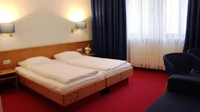 Ein Bett oder Betten in einem Zimmer der Unterkunft Hotel Restaurant Krokodil