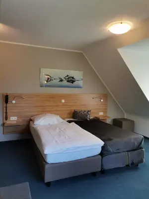 Ein Bett oder Betten in einem Zimmer der Unterkunft Landhaus Hotel Müller