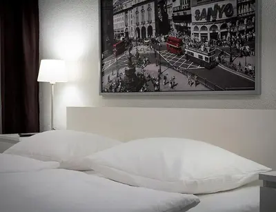 Ein Bett oder Betten in einem Zimmer der Unterkunft Hotel Krone Zentrum