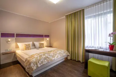 Ein Bett oder Betten in einem Zimmer der Unterkunft Hotel Stadt Heidelberg