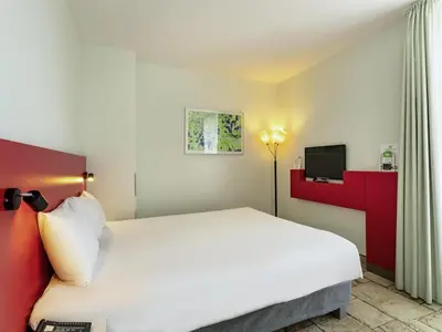 Ein Bett oder Betten in einem Zimmer der Unterkunft ibis Styles Karlsruhe Ettlingen