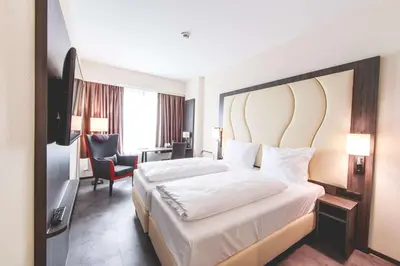 Ein Bett oder Betten in einem Zimmer der Unterkunft PLAZA INN Mannheim