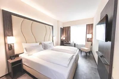 Ein Bett oder Betten in einem Zimmer der Unterkunft PLAZA INN Mannheim