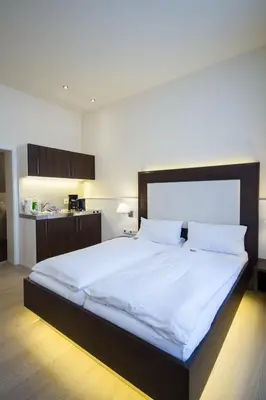 Ein Bett oder Betten in einem Zimmer der Unterkunft The Heidelberg Exzellenz Hotel