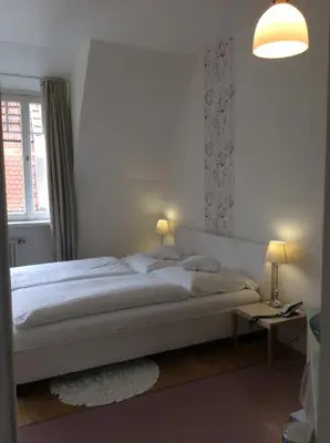 Ein Bett oder Betten in einem Zimmer der Unterkunft Hotel Heidelberg Astoria