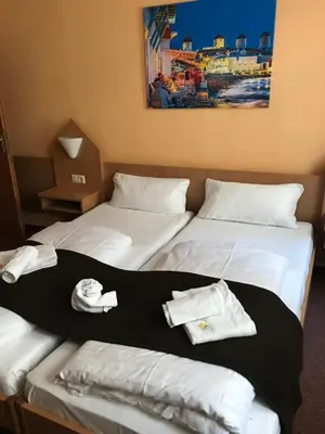 Ein Bett oder Betten in einem Zimmer der Unterkunft Poseidon Hotel