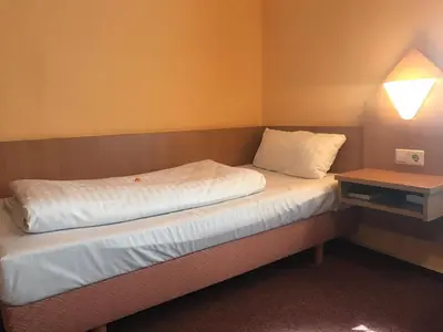 Ein Bett oder Betten in einem Zimmer der Unterkunft Poseidon Hotel