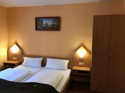 Ein Bett oder Betten in einem Zimmer der Unterkunft Poseidon Hotel