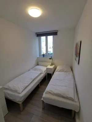 Ein Bett oder Betten in einem Zimmer der Unterkunft Ferienwohnungen Flussufer - Neckargemünd Altstadt