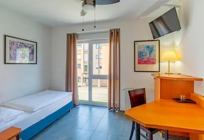 Ein Bett oder Betten in einem Zimmer der Unterkunft Heilbronner Hotel am schönen Theater