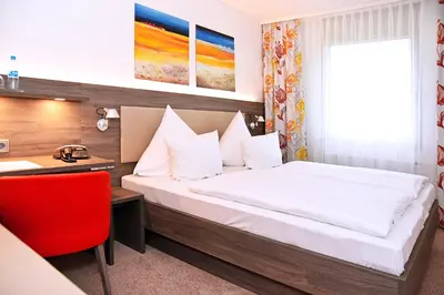 Ein Bett oder Betten in einem Zimmer der Unterkunft GenoHotel Karlsruhe