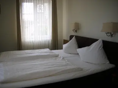 Ein Bett oder Betten in einem Zimmer der Unterkunft Hotel Am Schloss