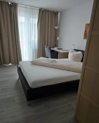 Ein Bett oder Betten in einem Zimmer der Unterkunft Hotel Ackermann