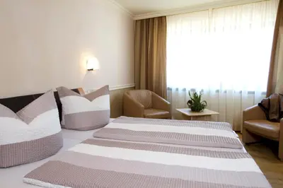 Ein Bett oder Betten in einem Zimmer der Unterkunft Gästehaus Hebinger am Schlosspark
