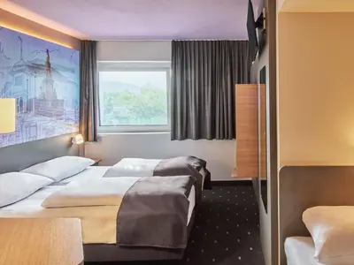 Ein Bett oder Betten in einem Zimmer der Unterkunft B&B Hotel Heidelberg
