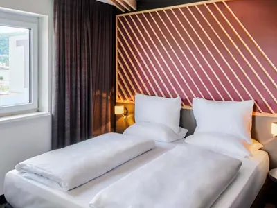 Ein Bett oder Betten in einem Zimmer der Unterkunft B&B Hotel Heidelberg