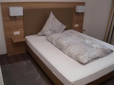 Ein Bett oder Betten in einem Zimmer der Unterkunft Hotel Anker garni