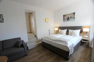 Ein Bett oder Betten in einem Zimmer der Unterkunft Hotel Adler